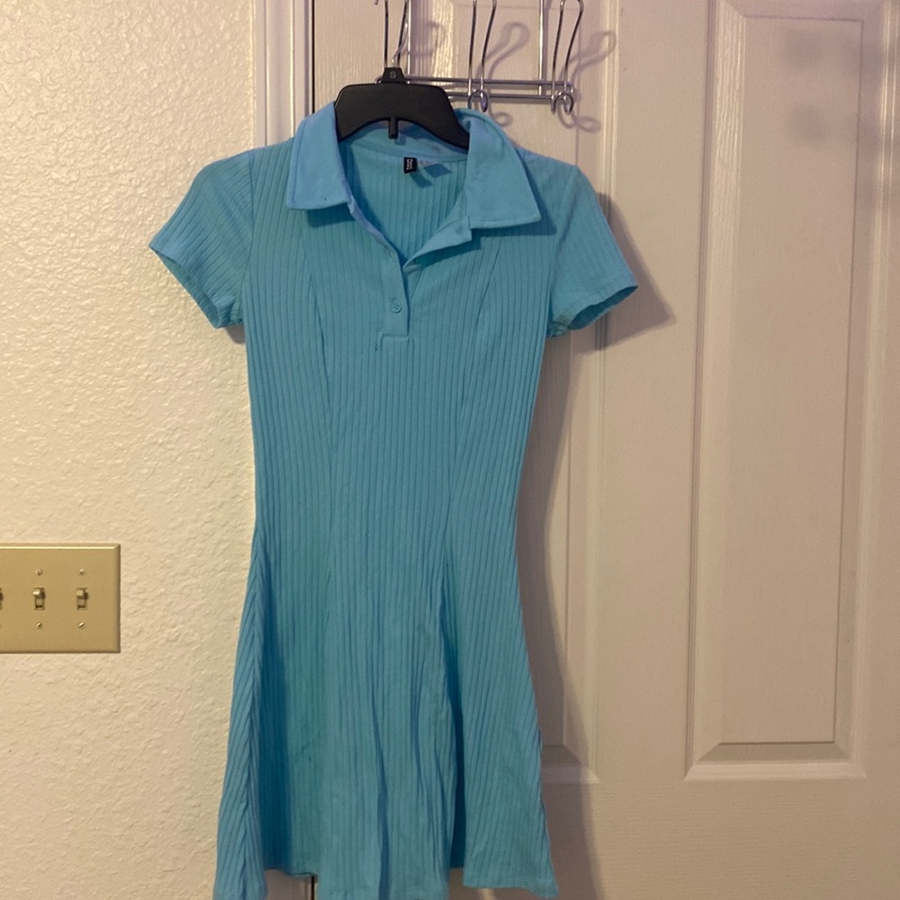 A light blue casual dress that’s tight at the top and flowly at the bottom.
